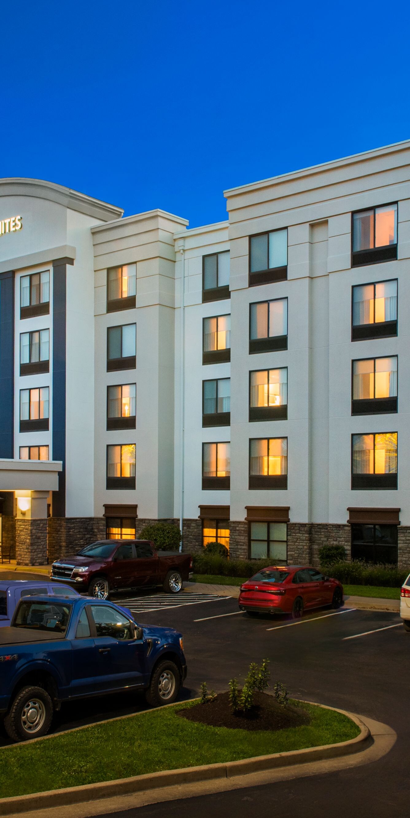 Exterior of hotel and parking lot at night