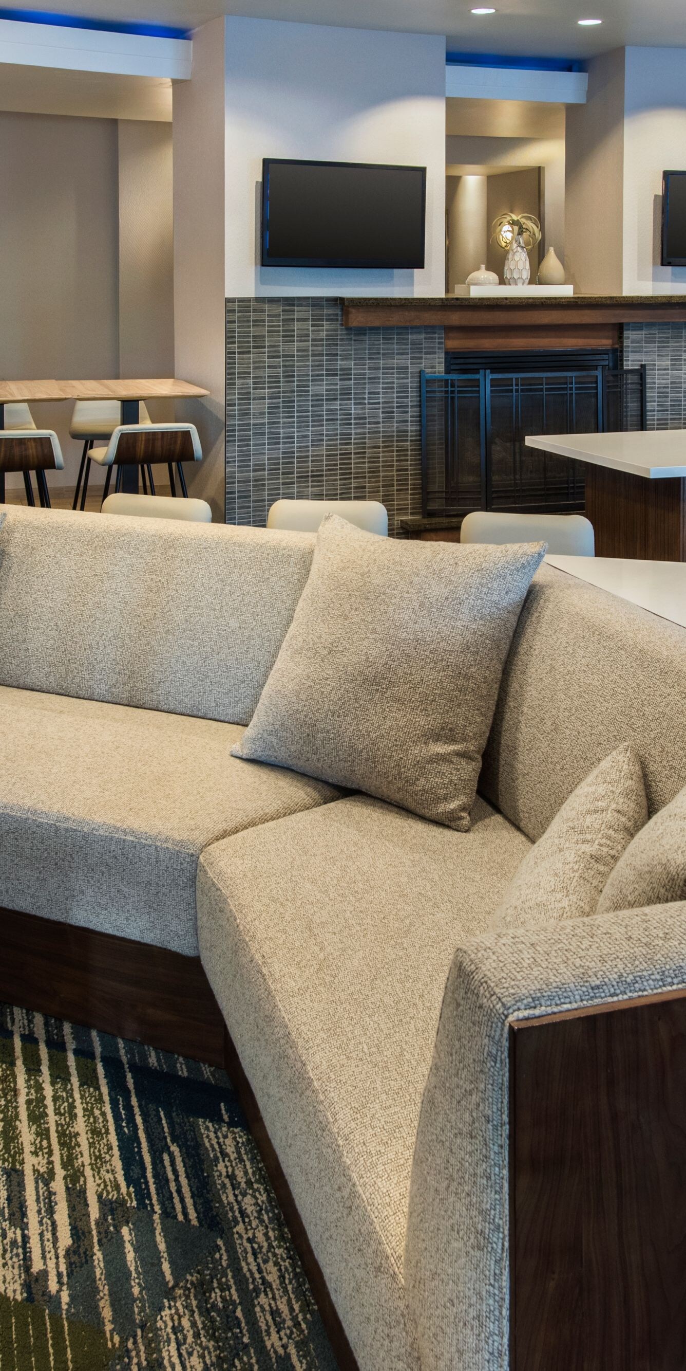Lobby lounge with sectional and fireplace