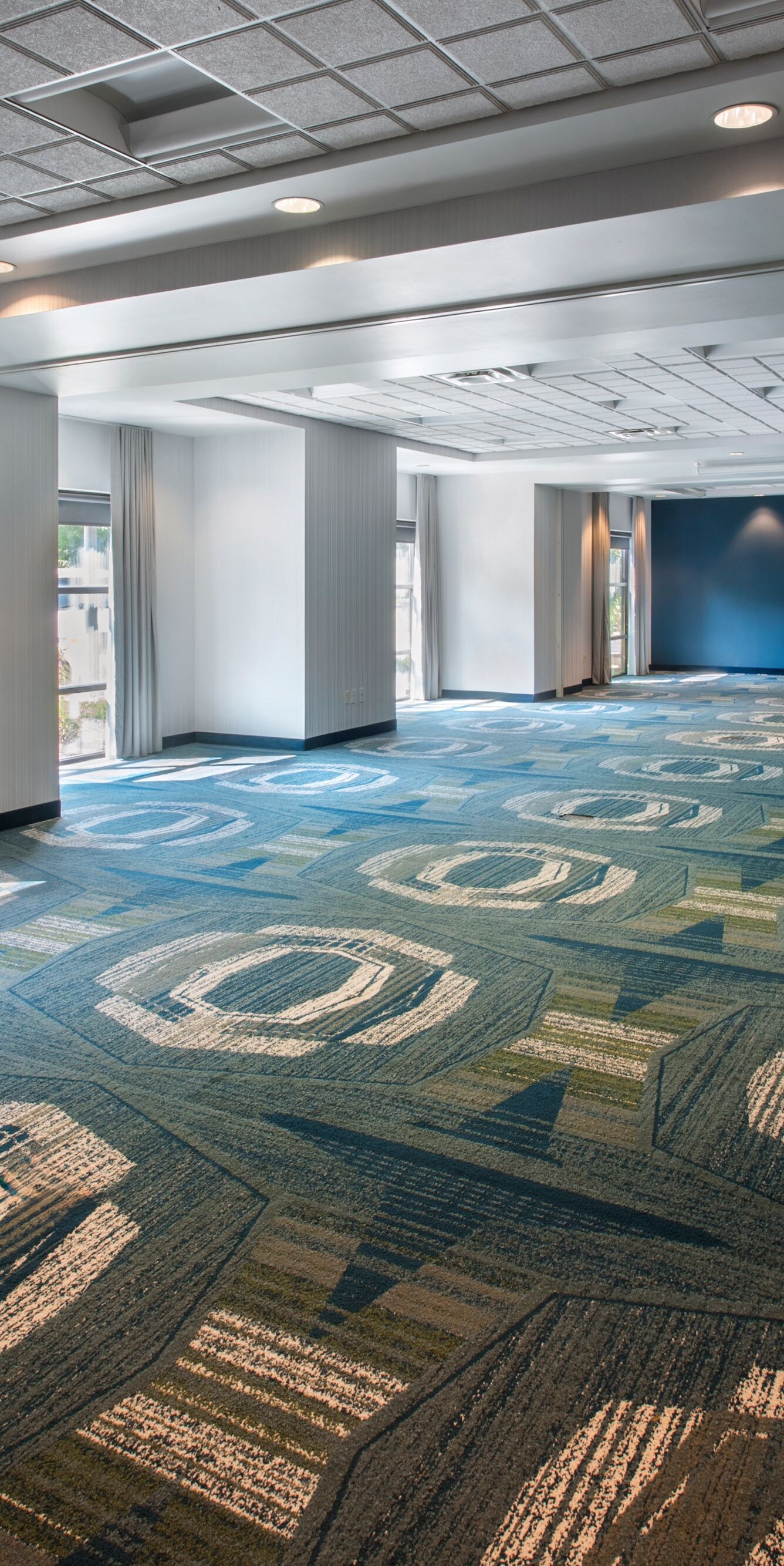 meeting space with patterned carpet and windows