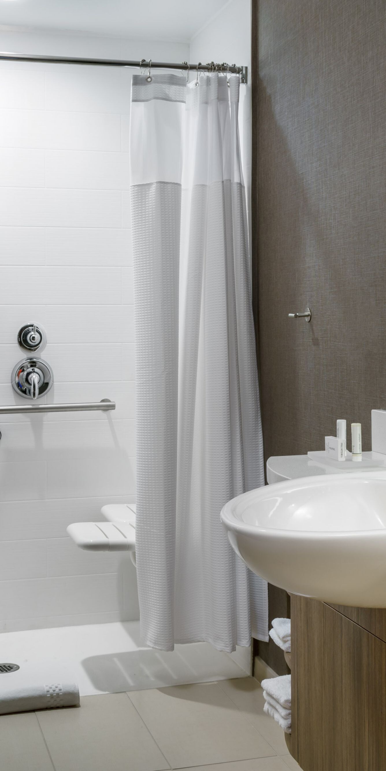 Accessible roll-in shower with grab bars