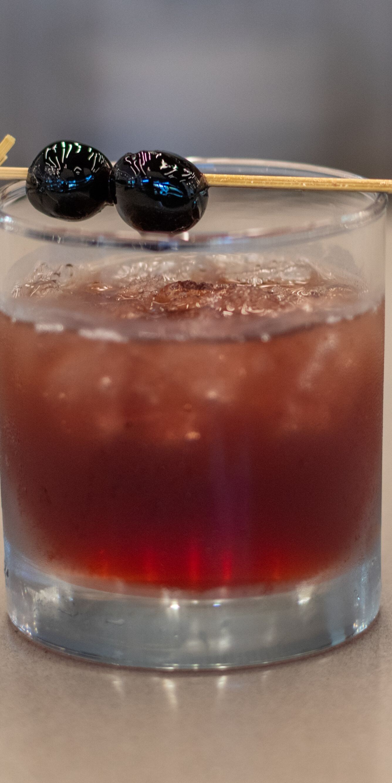 Red iced cocktail with cherry garnish