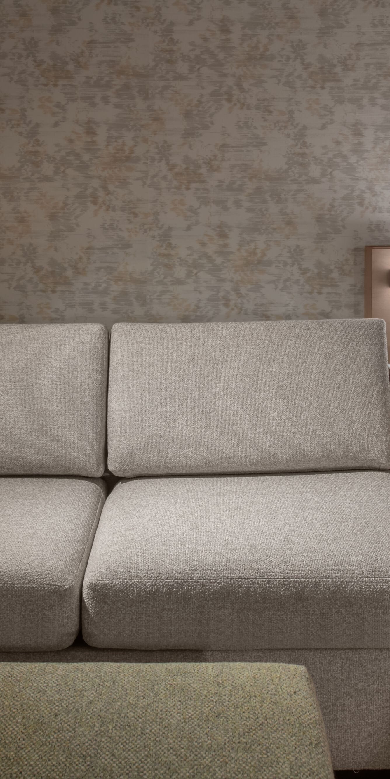 Sofa beside king bed in guest room