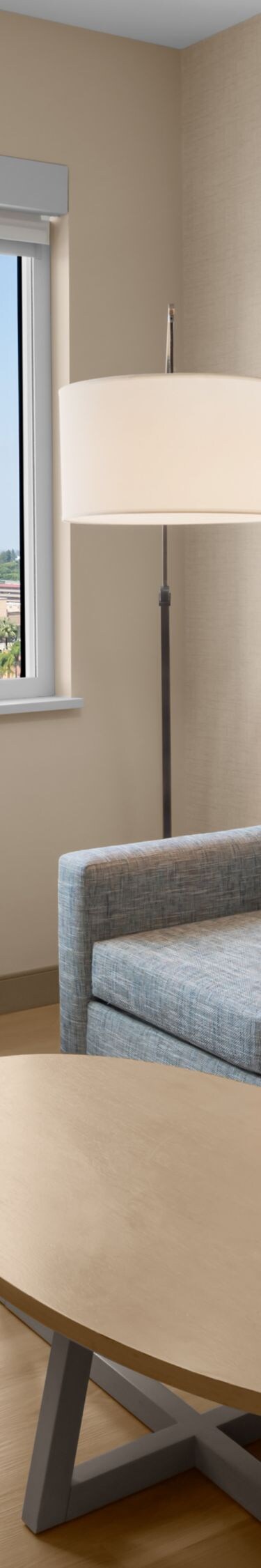 Guest room seating area with TV and window open