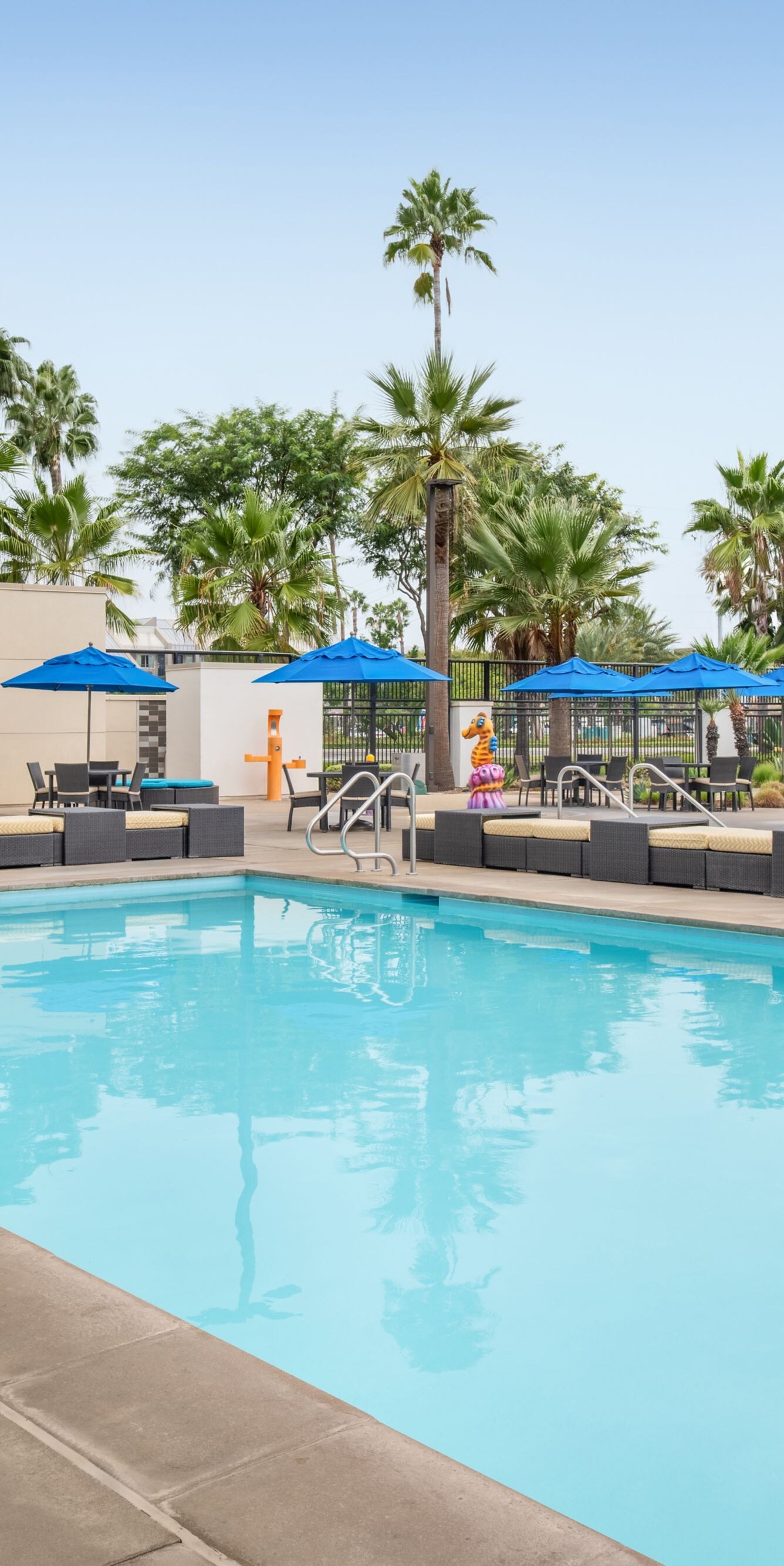 Outdoor pool near movie wall