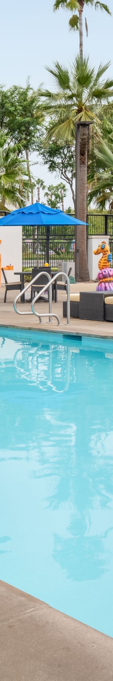 Outdoor pool near movie wall