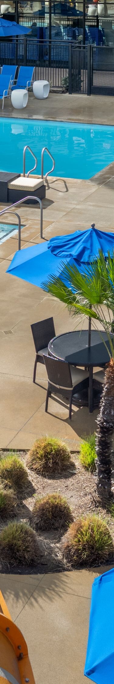 Aerial view of pools, pool seating, and slide