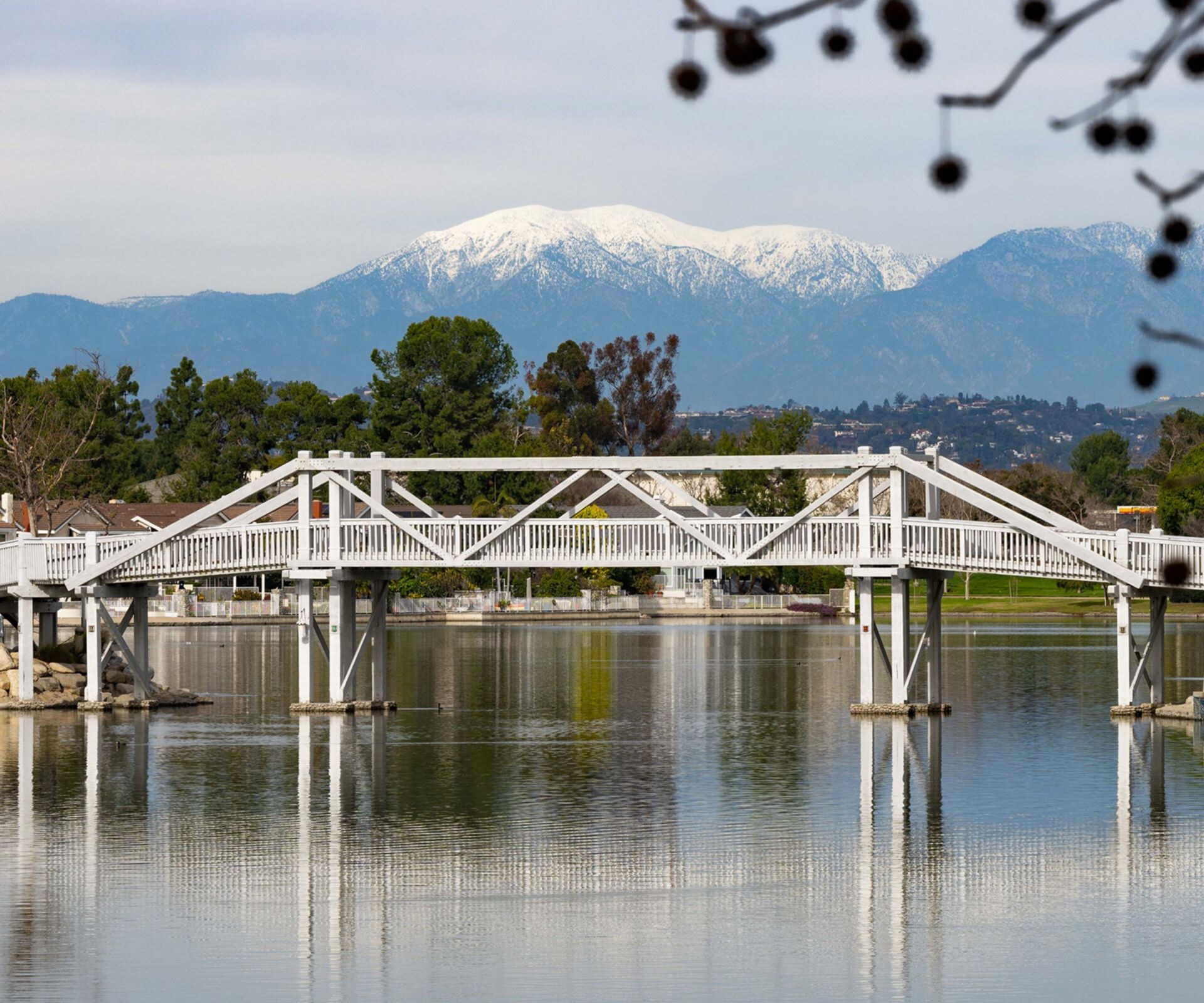 white pedestrian bridge over calm water