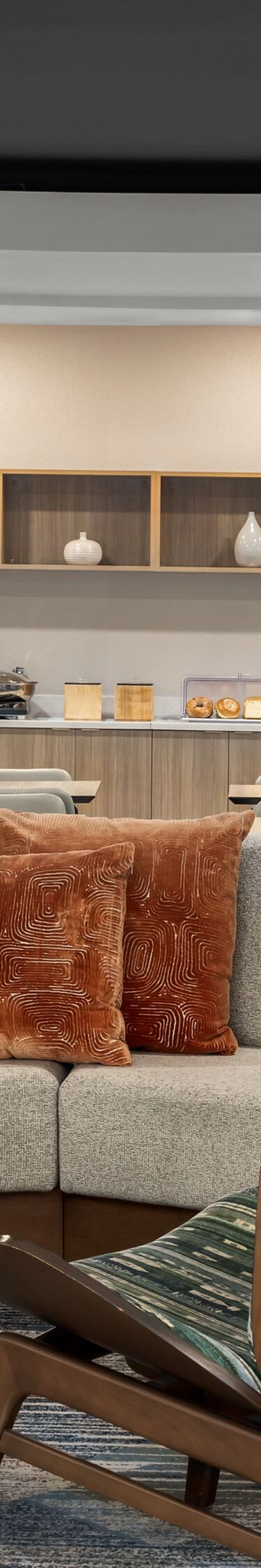 Casual lobby seating with breakfast buffet behind