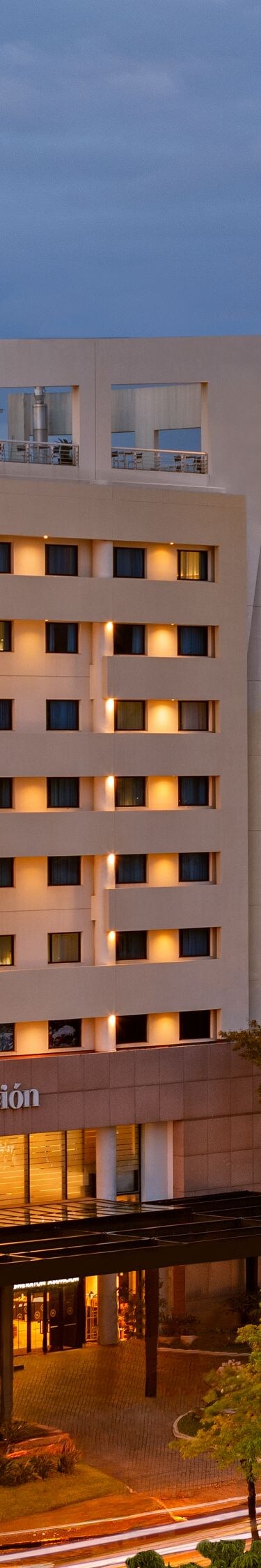 Exterior of the hotel building with city skyline