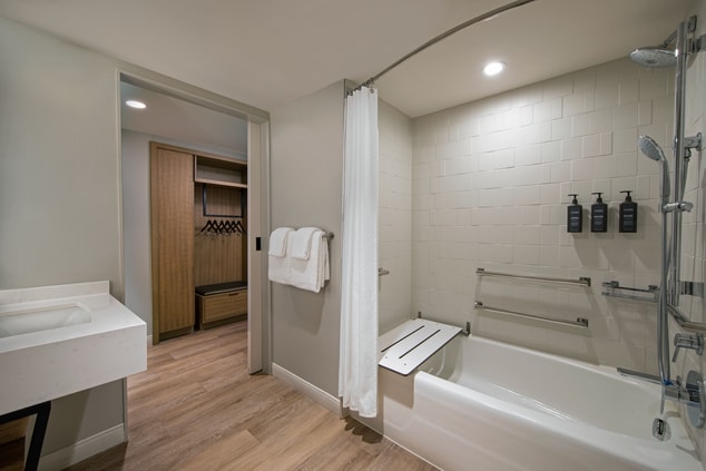 ADA Bathtub with sink and closet nearby
