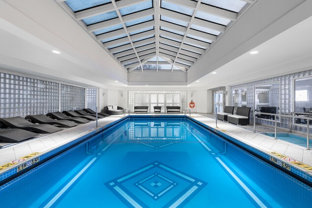 Indoor pool with pool chairs around