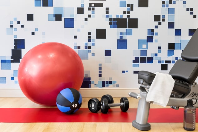 Close up of weights, yoga ball, and bench