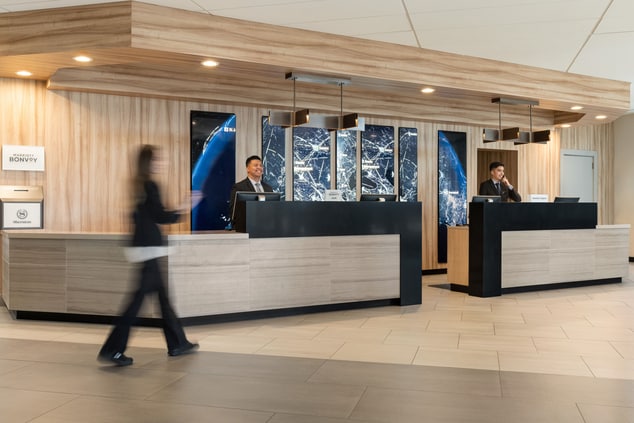 Front desk with employees behind counter
