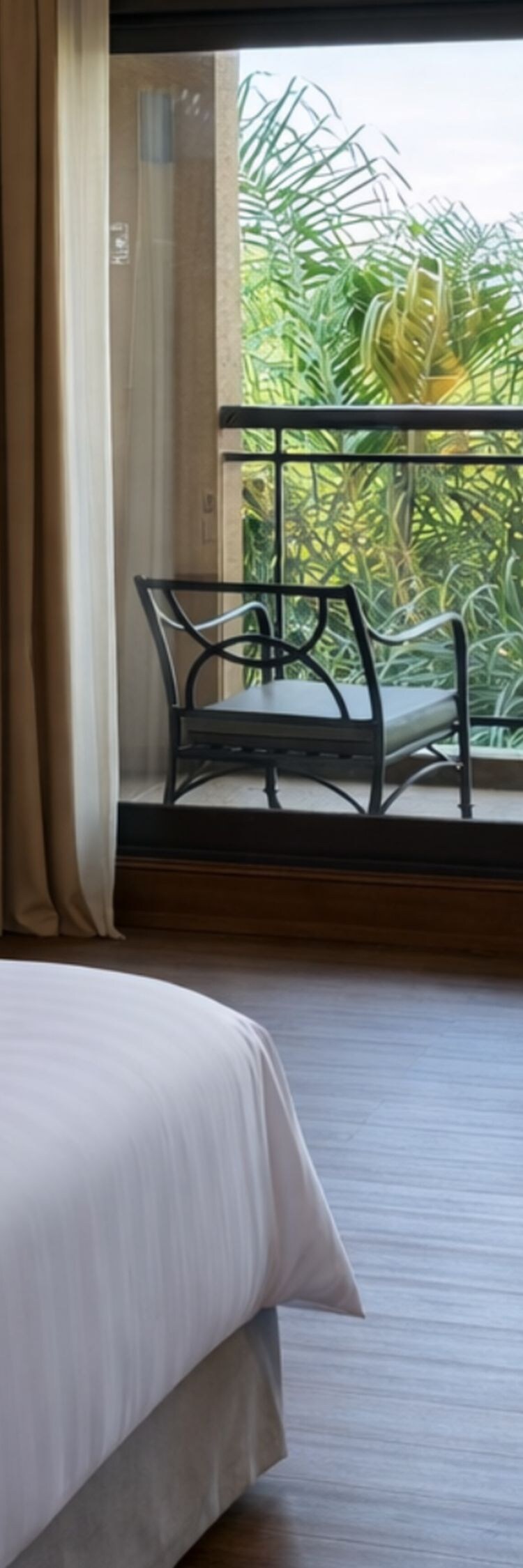 bed, armchair, ottoman, lamps, and balcony