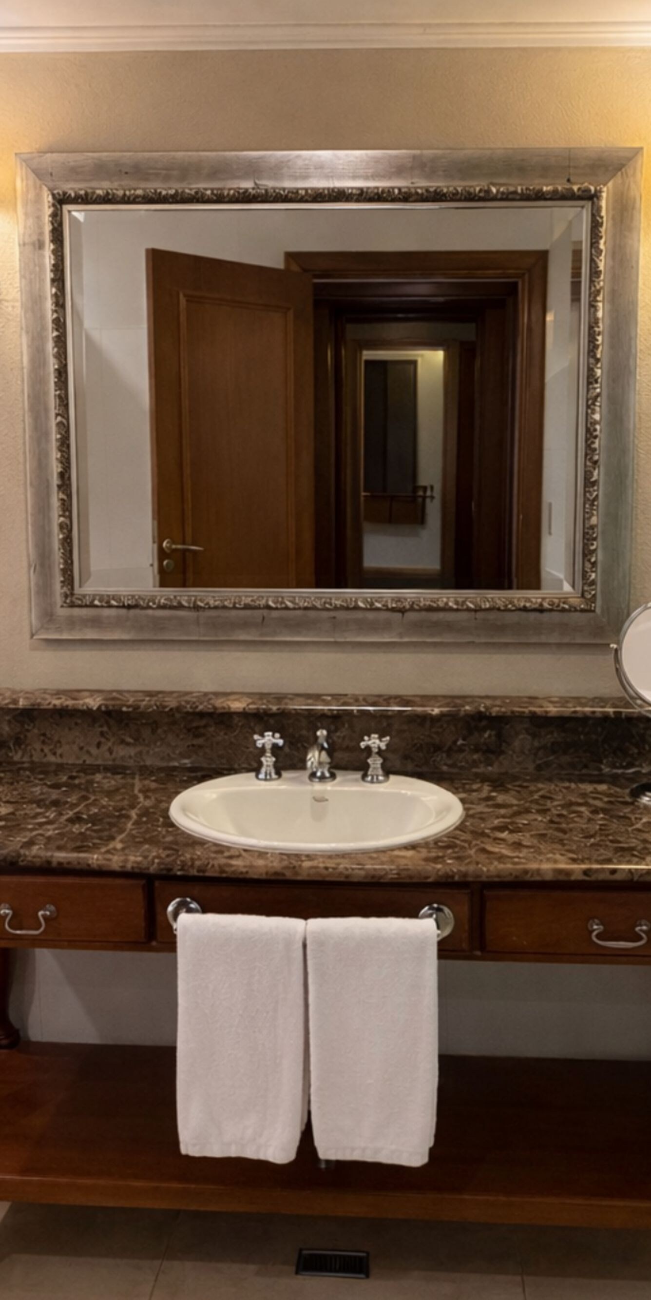 bathtub and marble and wood vanity