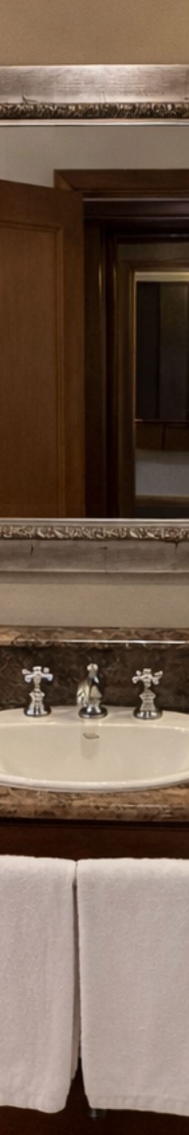 bathtub and marble and wood vanity