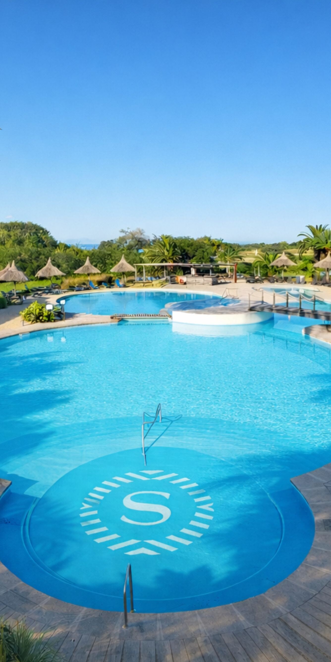 Outdoor Pool surrounded by loungers