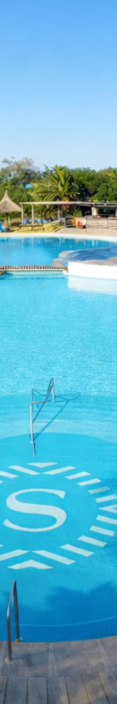 Outdoor Pool surrounded by loungers