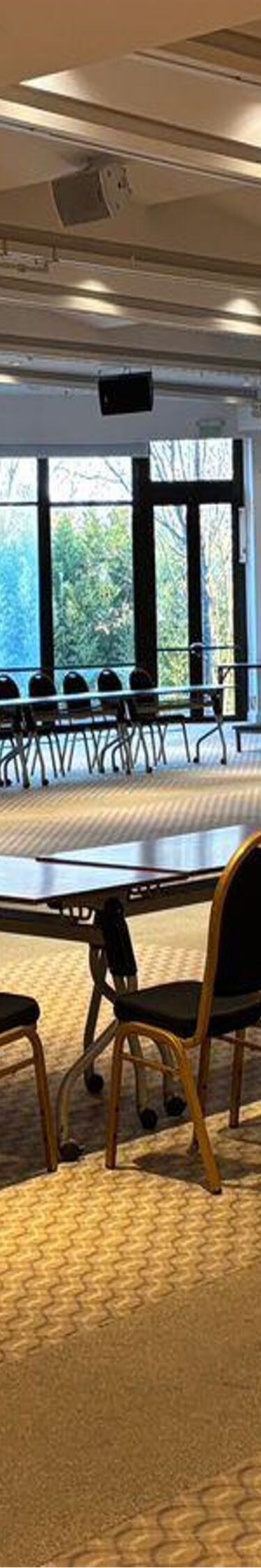 U-shaped conference table with chairs and screen