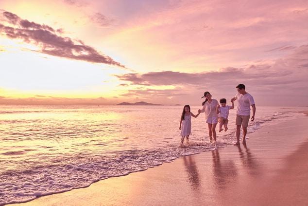 Family beach walk at dusk