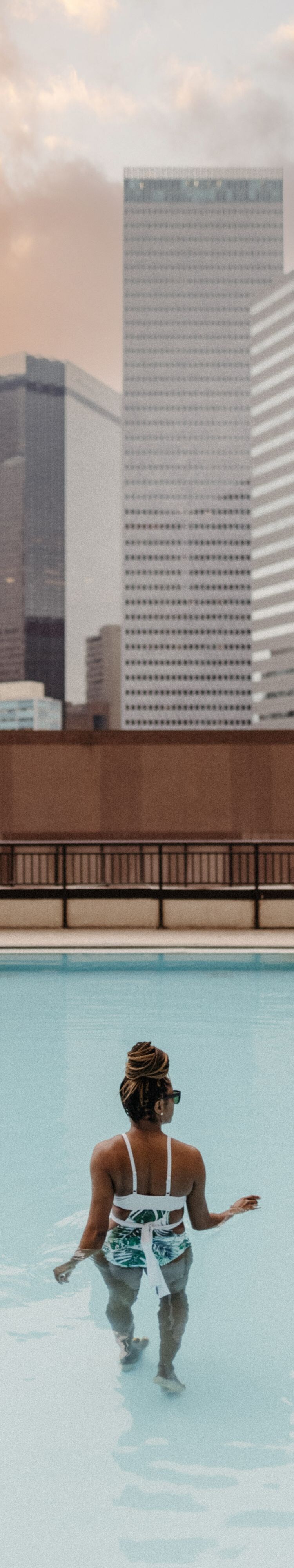 Woman standing in rooftop pool