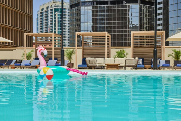 image of pool with flamingo floaties