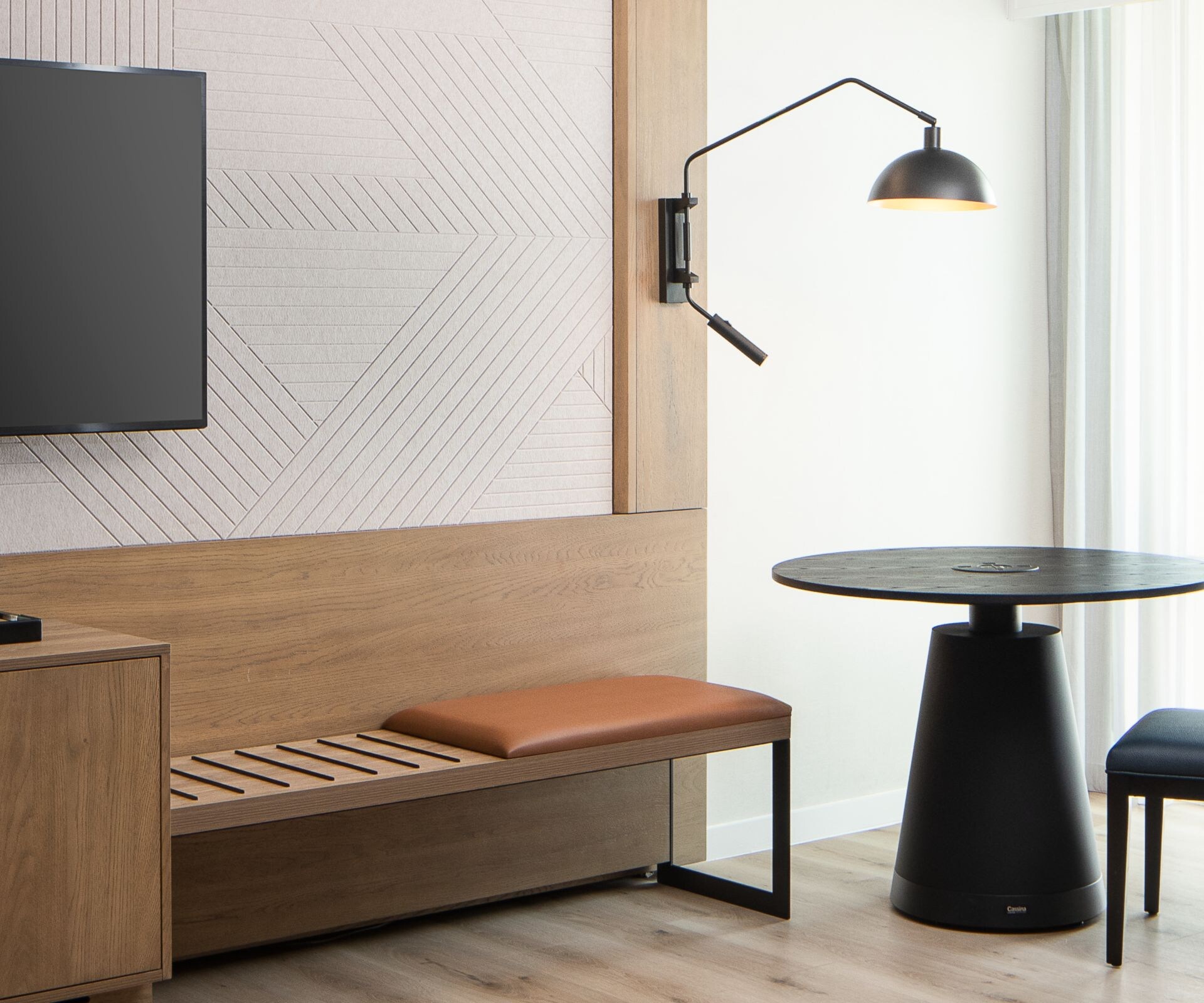 Spacious guestroom with table and chair