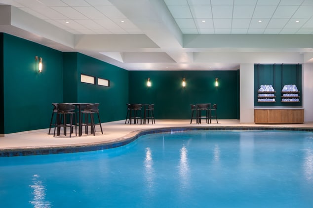 Indoor Heated Pool with tables and chairs