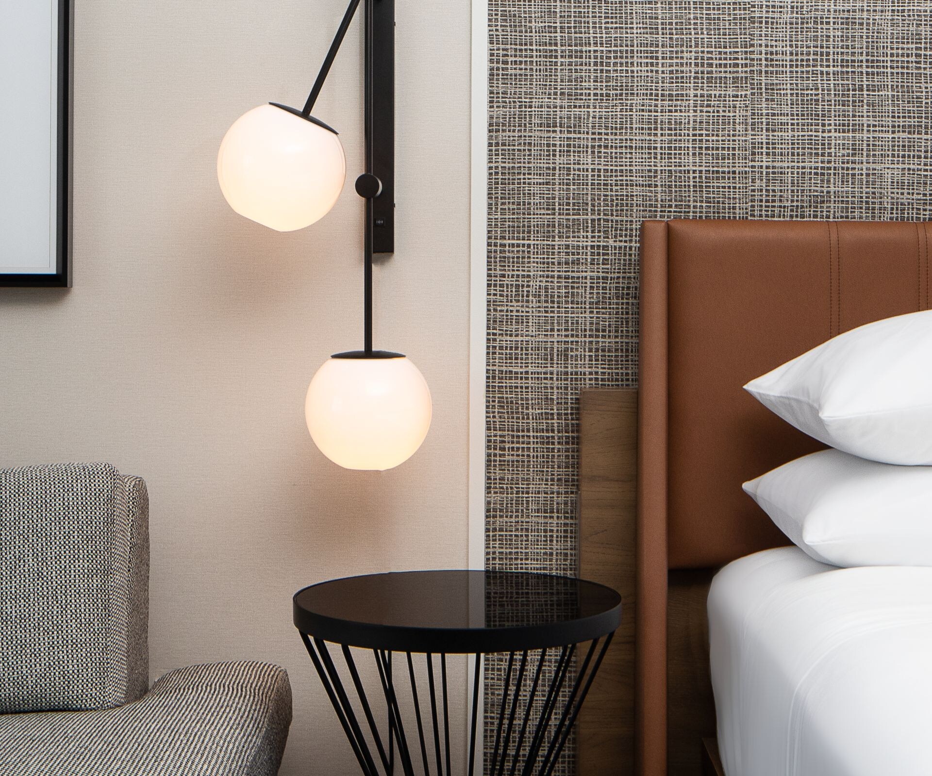 Guestroom with bed, sofa and sconce