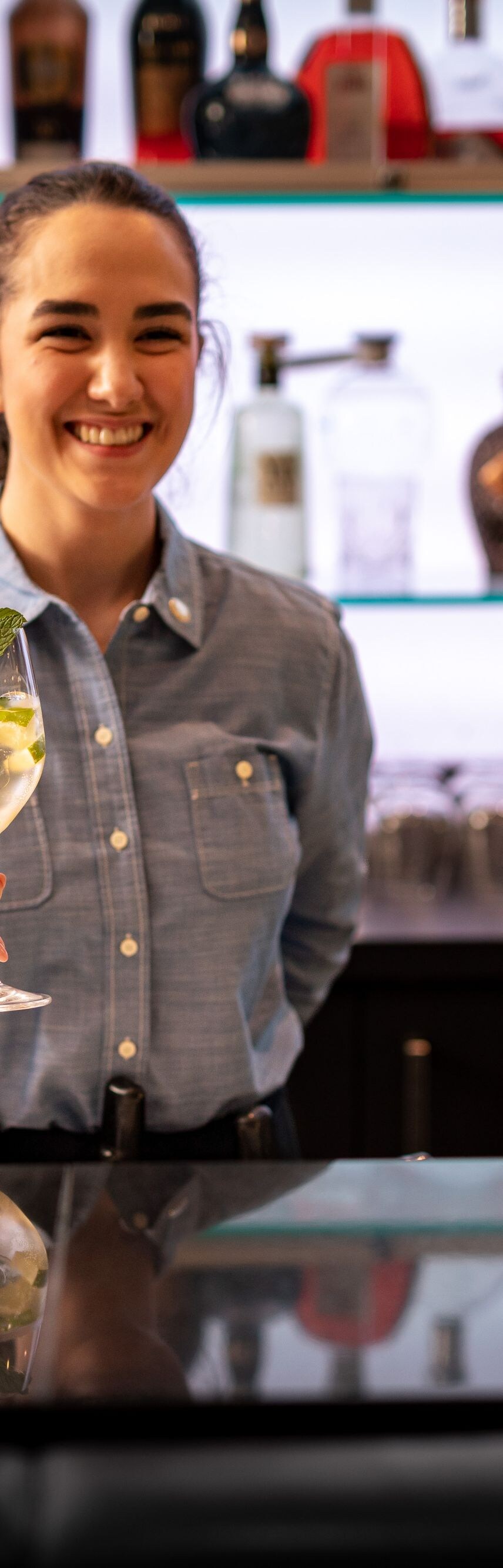 Waitress serving a drink at the bar