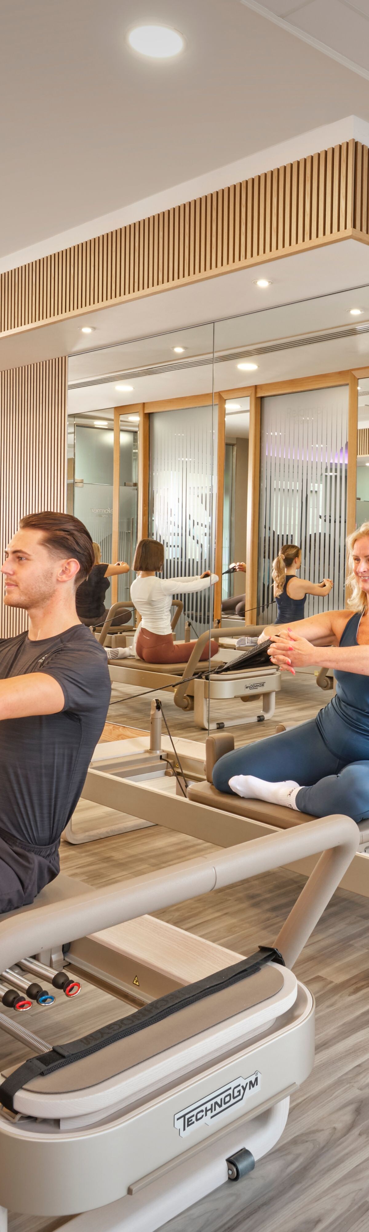 Instructor and guests in Reformer class