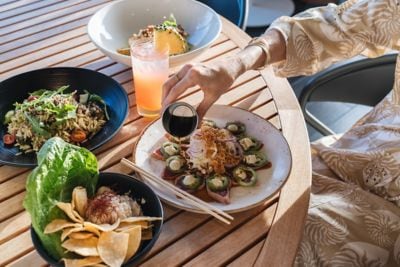 A guest enjoys a beautifully plated island-inspire