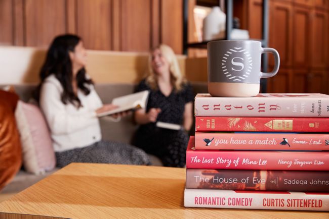 Reese’s Book Club with two women, book stack