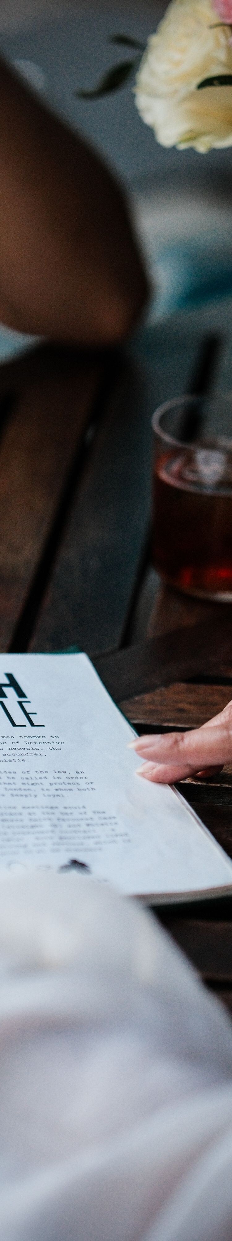 Open menu next to cocktails on table