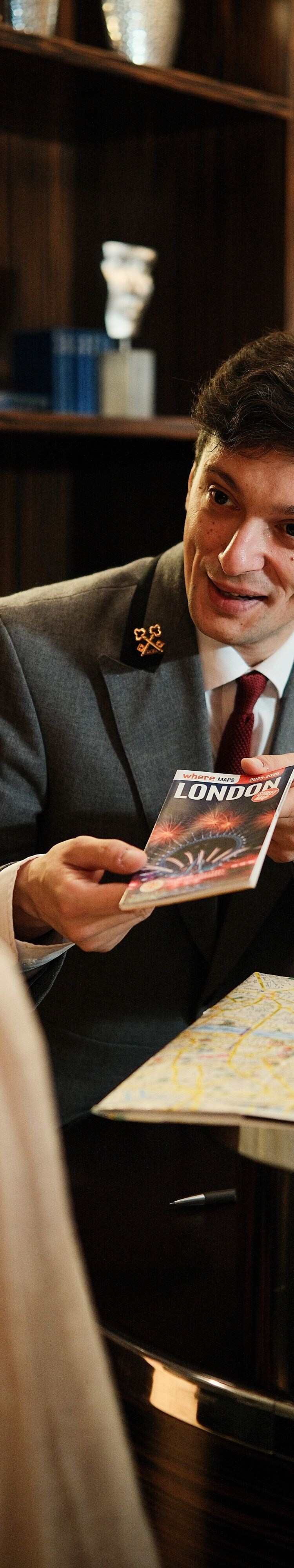 Concierge handing brochure to guest