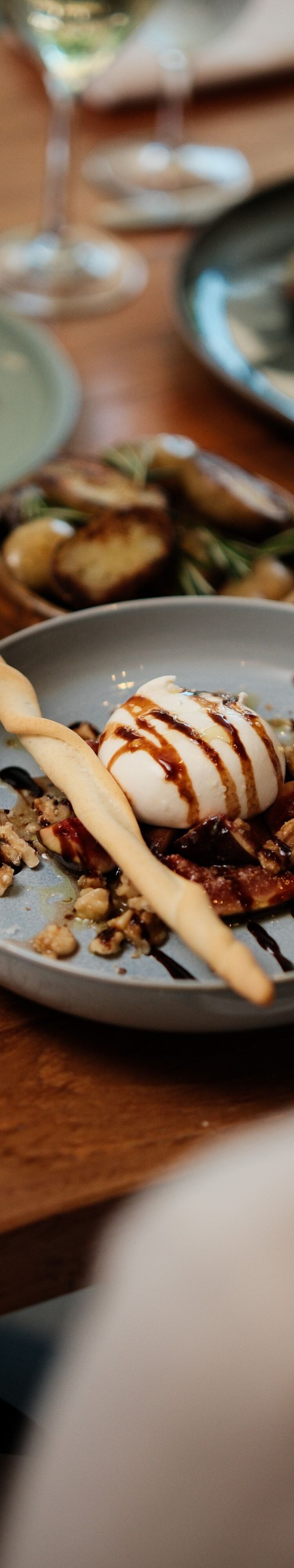 Plated burrata starter placed on dinner table