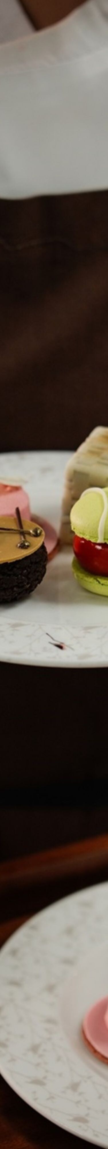 Plated cakes held above serving tray