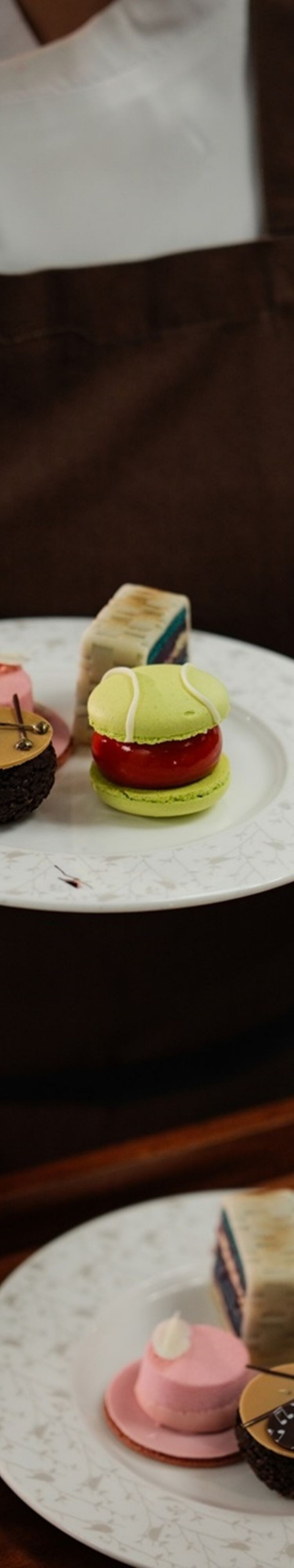 Plated cakes held above serving tray