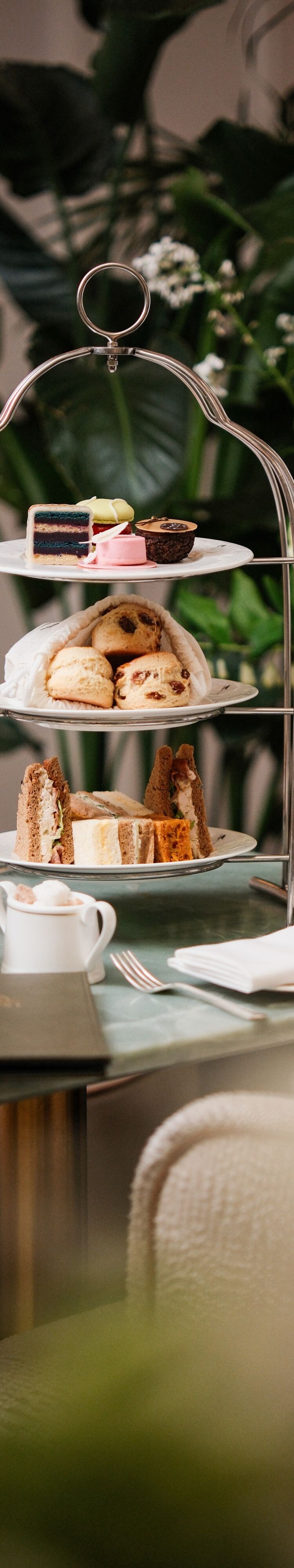Tiered afternoon tea stand with teapot and cups