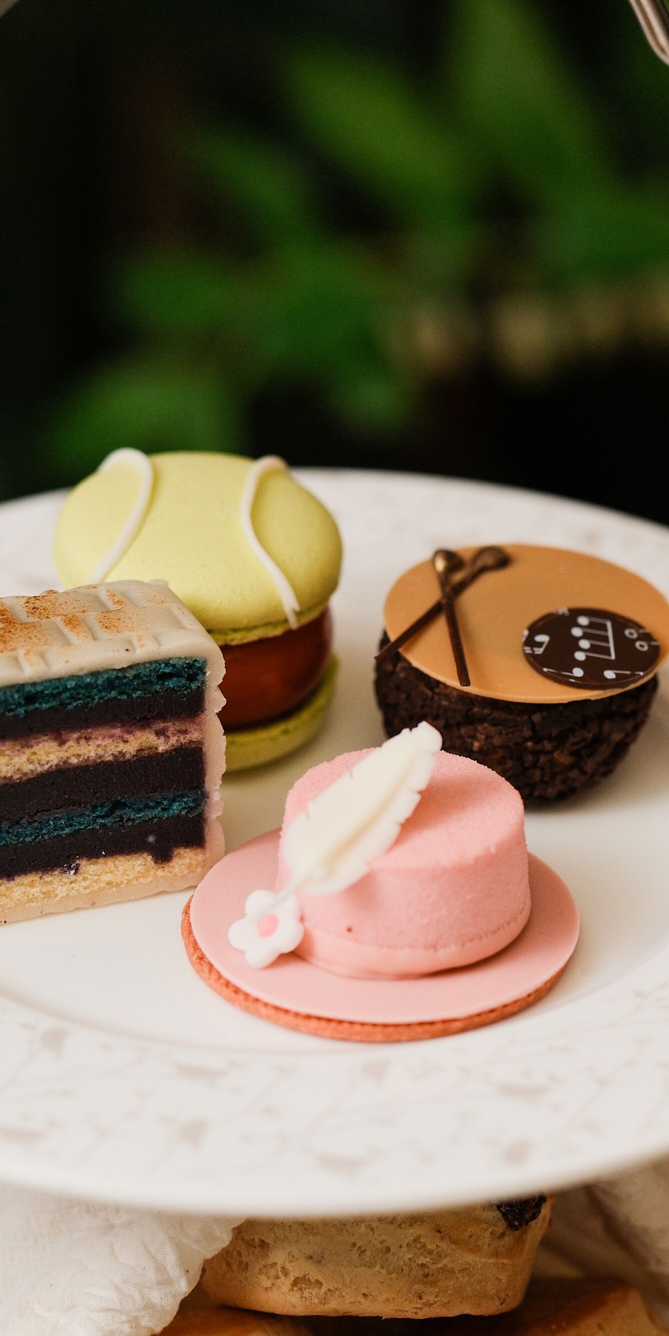 Assorted cakes on top tier of afternoon tea stand
