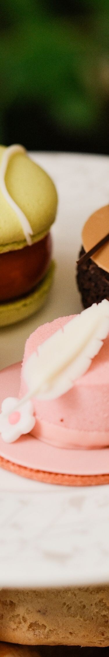 Assorted cakes on top tier of afternoon tea stand