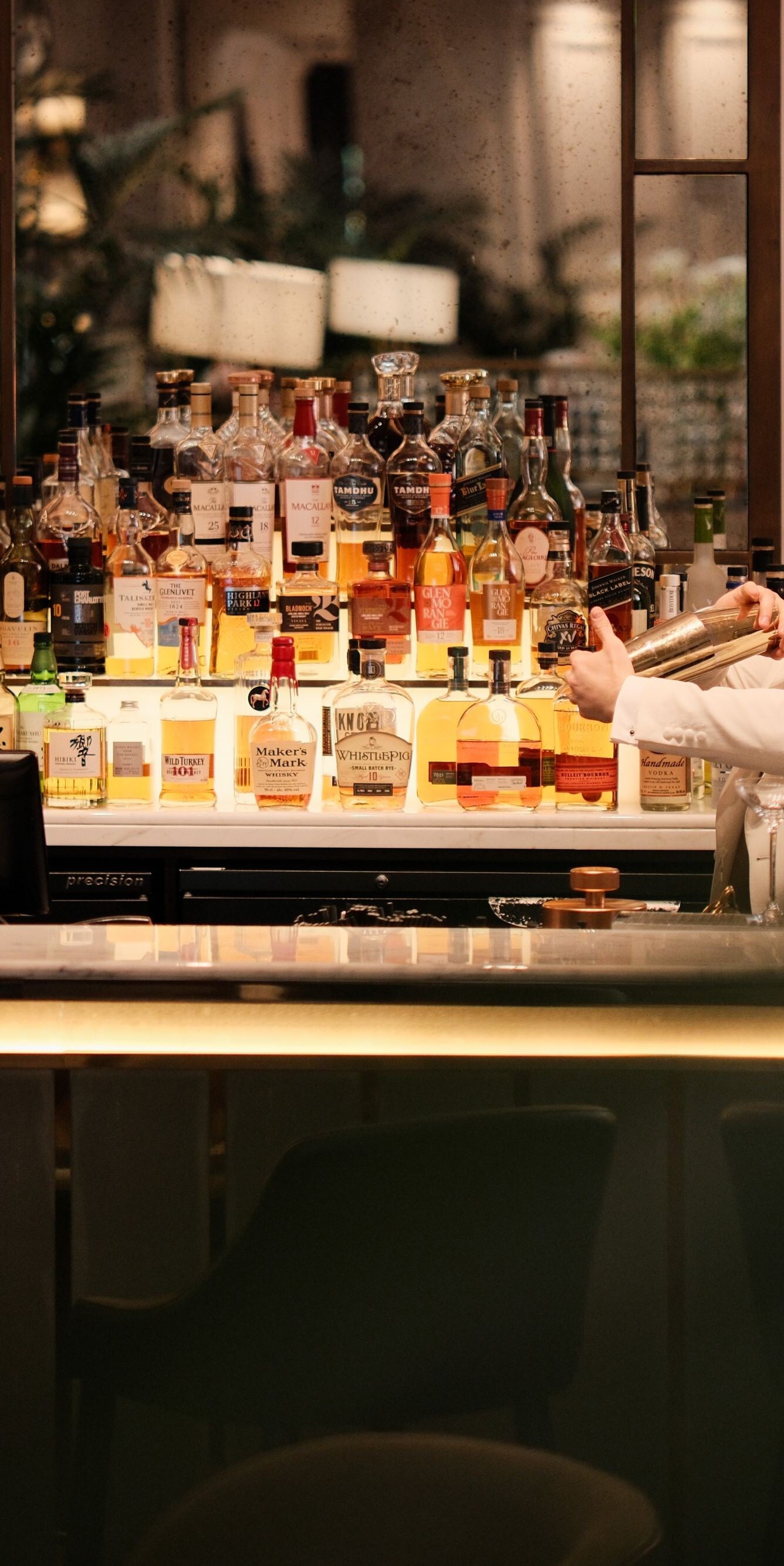 Bartender preparing cocktail behind bar counter