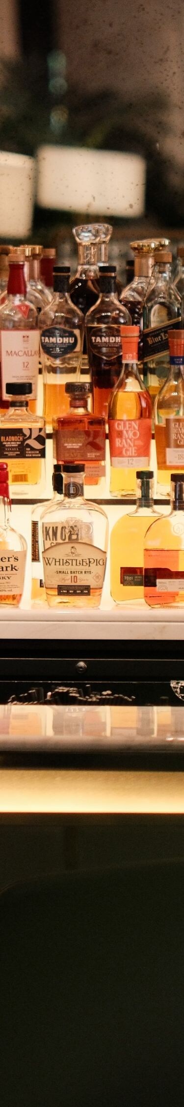 Bartender preparing cocktail behind bar counter