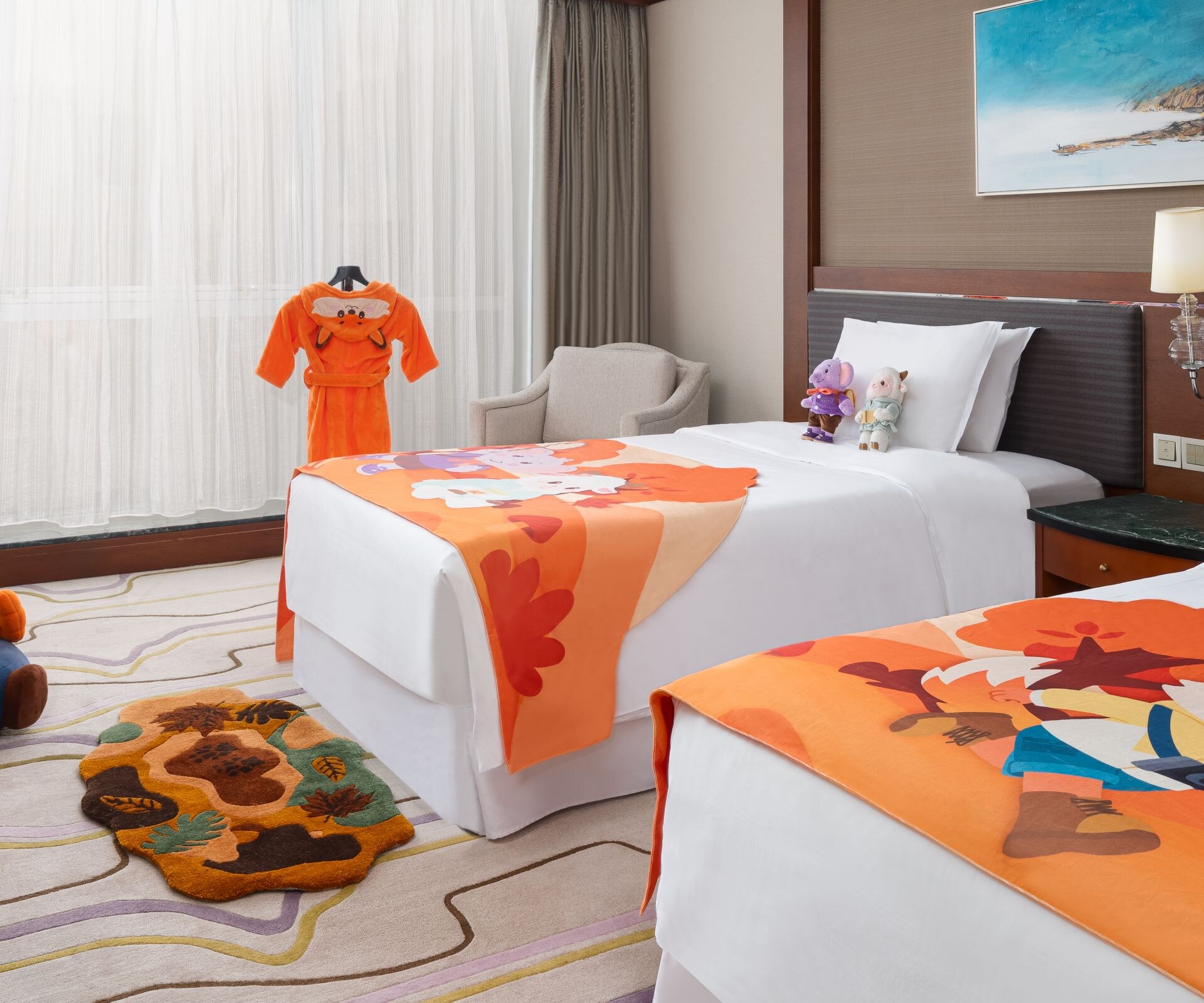 themed room, two beds, tv, table, and chairs