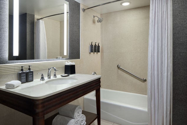 Vanity and tub with handrail