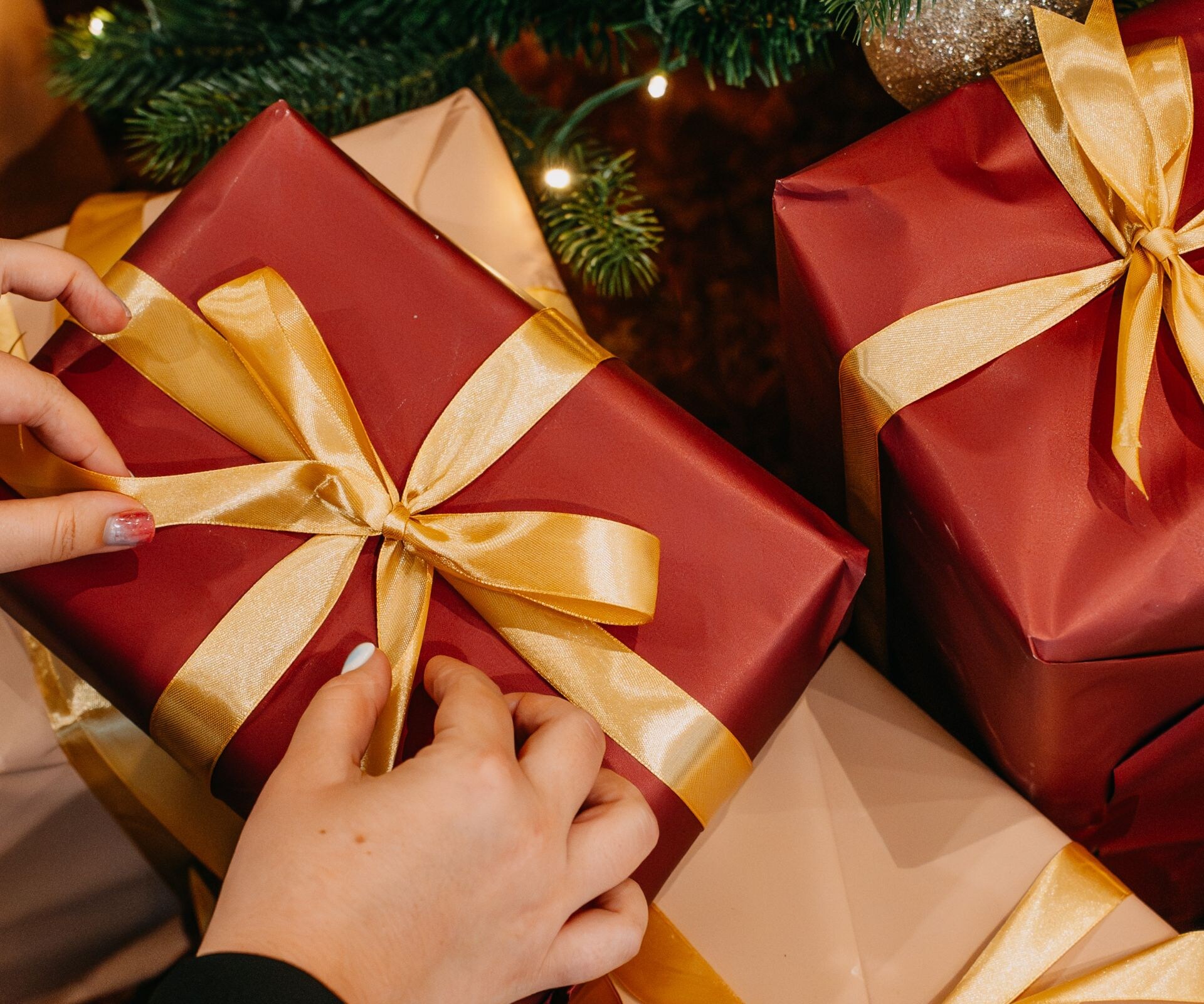 Wrapped gifts arranged under Christmas tree