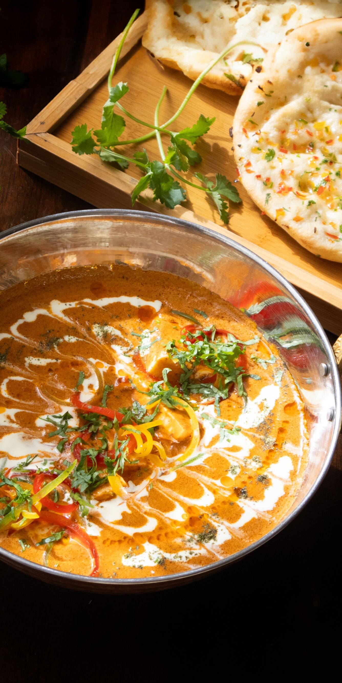 Curry with naan and fresh herbs
