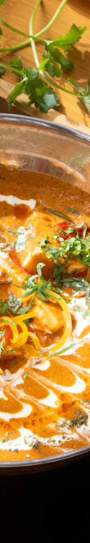 Curry with naan and fresh herbs