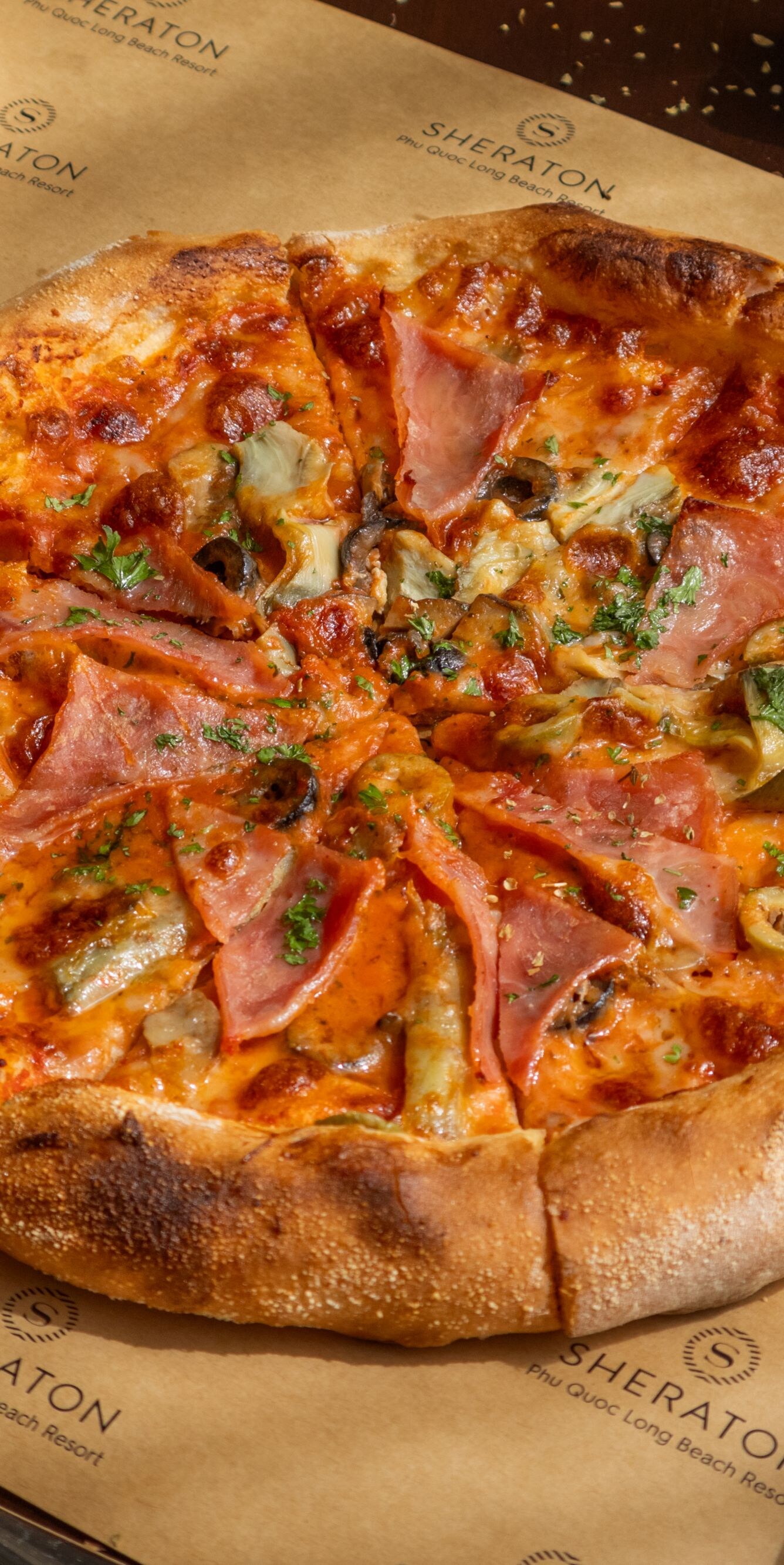Artisanal pizza with ham and olives