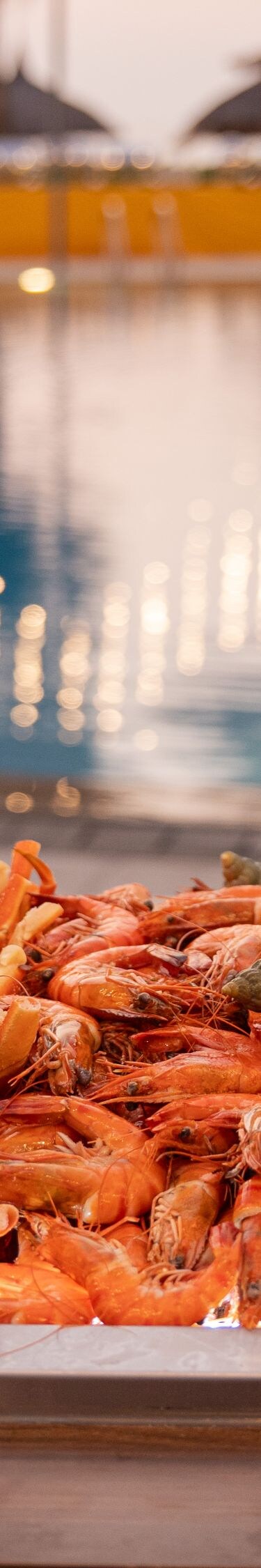 Seafood buffet with pool and string lights